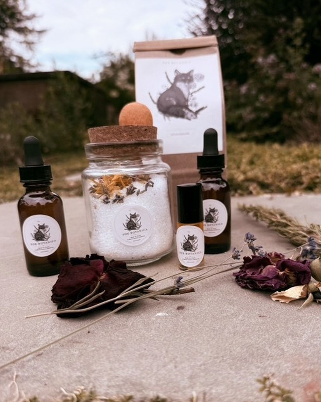 Fox Botanica amber bottles, herbal salt and dried flowers arranged among the garden's winter stems.